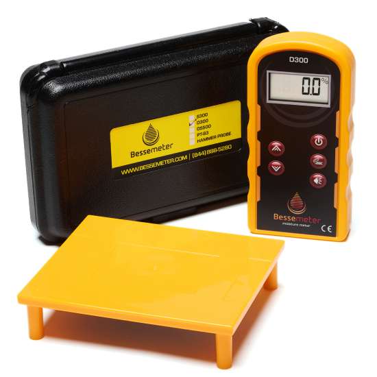 The Bessemeter D300, its black carrying case, and the calibration verification block