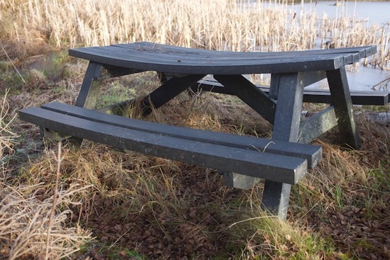 A picnic table that has bowed due to wood movement